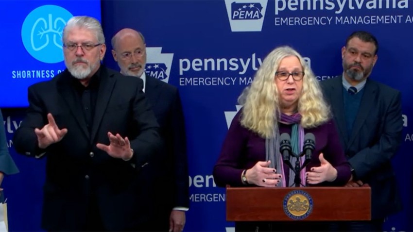Woman at a podium with people behind her