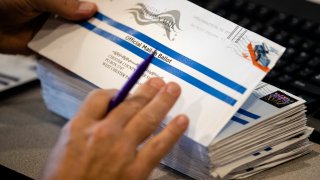 Dave Turnier processes mail-in ballots at at the Chester County Voter Services office in West Chester, Pa., prior to the primary election, Thursday, May 28, 2020.