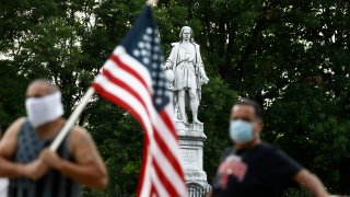 People gather near the statue of Christopher Columbus at Marconi Plaza, Monday, June 15, 2020, Philadelphia.