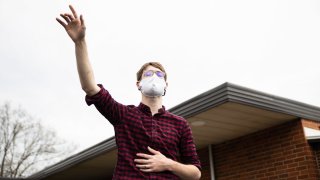 In this April 12, 2020, file photo, a devotee worships while wearing a face mask as a preventive measure against COVID-19 during an Easter Sunday church service in Ohio.