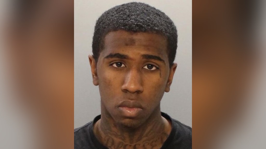 Xavier Johnson looks at the camera in a police mug shot.