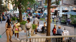 Diners and walkers socially distanced on a street