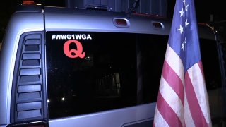 SUV with an American flag and a QAnon sticker