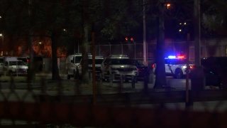 Philadelphia police vehicles behind a wire fence