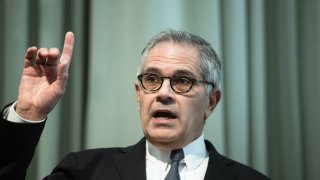 Larry Krasner holding a finger up during a news conference