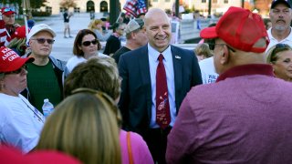 Pennsylvania state Sen. Doug Mastriano, R-Franklin, center, speaks to supporters of President Donald Trump as they demonstrate outside the Pennsylvania State Capitol,