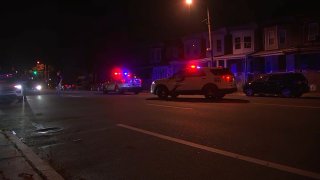 Philadelphia police vehicles block off a street in the Nicetown neighborhood, following a fatal hit-and-run