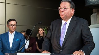 David Cohen standing at a meeting.