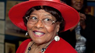 Ex-Camden Mayor Gwen Faison smiles as she wears a hat.