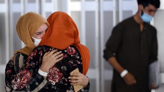 A woman embraces her sister-in-law