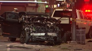 The front end of a black SUV is caved in following a fatal crash in Philadelphia.