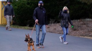 President Joe Biden and first lady Jill Biden take their dog Commander for a walk