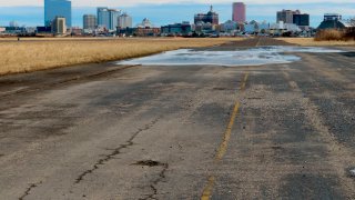 This Feb. 18, 2022 photo shows a pot-holed runway at the former Bader Field airport site in Atlantic City, N.J. with casinos in the background. His company is proposing a $2.7 billion auto-centric development including a driving course and 2,000 housing units on the site of the first aviation facility in America to be called an "airport."