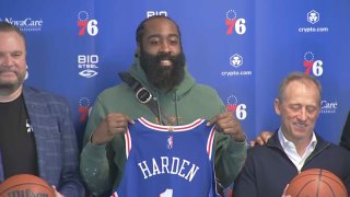 James Harden holds up Sixers Jersey
