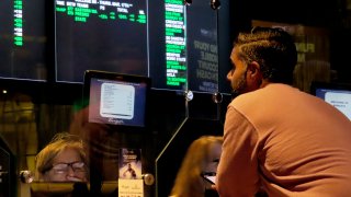 A customer makes a sports bet at the Borgata casino in Atlantic City N.J. on March 17, 2022 just before the March Madness college basketball tournament began