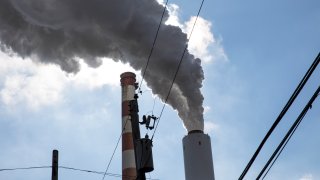 Smoke rises from a smokestack of a power plant