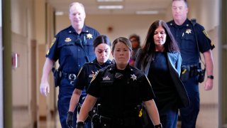 Former Pennsylvania Attorney General Kathleen Kane, second from right, is led to court as she arrives for a hearing on an alleged probation violation, at the Montgomery County Courthouse in Norristown, Pa., Monday, May 23, 2022.