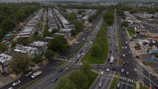 The Philadelphia skyline, top, is seen at a distance as vehicular traffic flows along Roosevelt Boulevard at the intersection with Whitaker Avenue, Thursday, May 12, 2022, in Philadelphia.