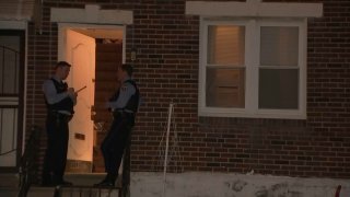 Police officers outside open door of Northeast Philadelphia home