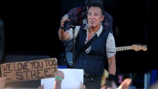 Bruce Springsteen on stage holding a mic