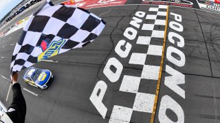 Chase Elliott's car crosses the finish line at Pocono Speedway