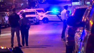 Police officers and a police car block a Philly street