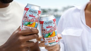 People cheers with cans of Cape May Brewing Company's Wawa-themed Shore Tea