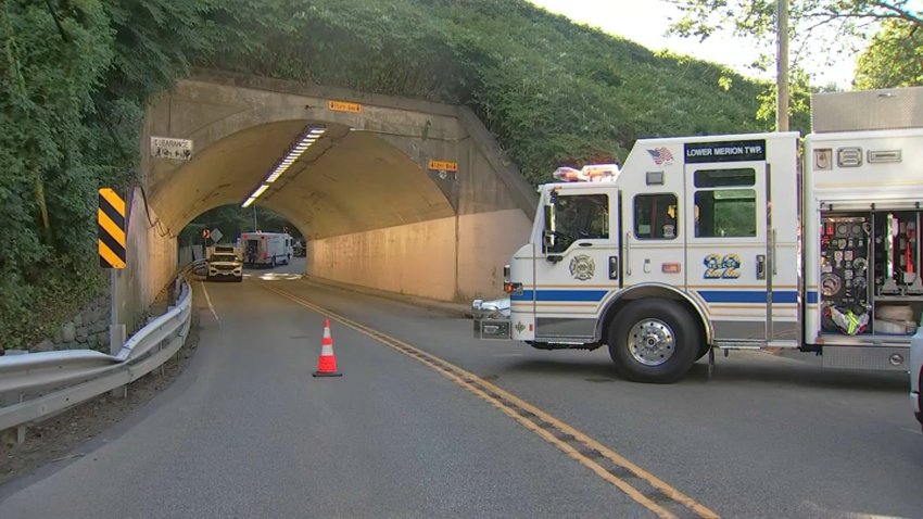 A rescue truck parks at the entrance of a tunnel.