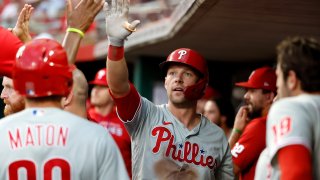 Rhys Hoskins high fives Phillies teammates