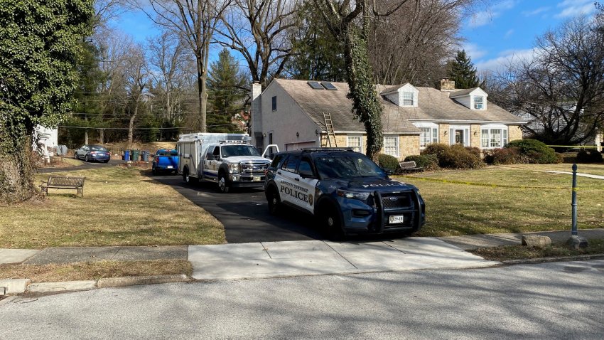 Police SUV parked outside house on sunny day