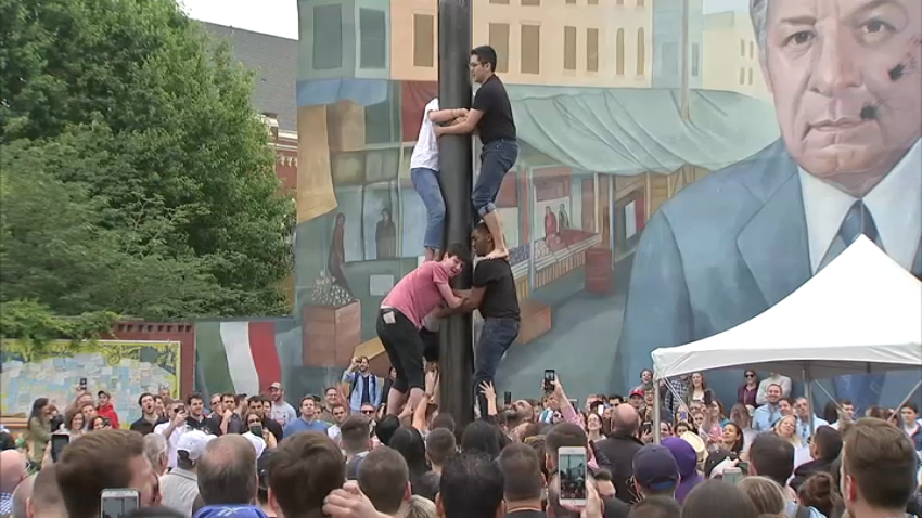 People climb Italian Market's greased pole
