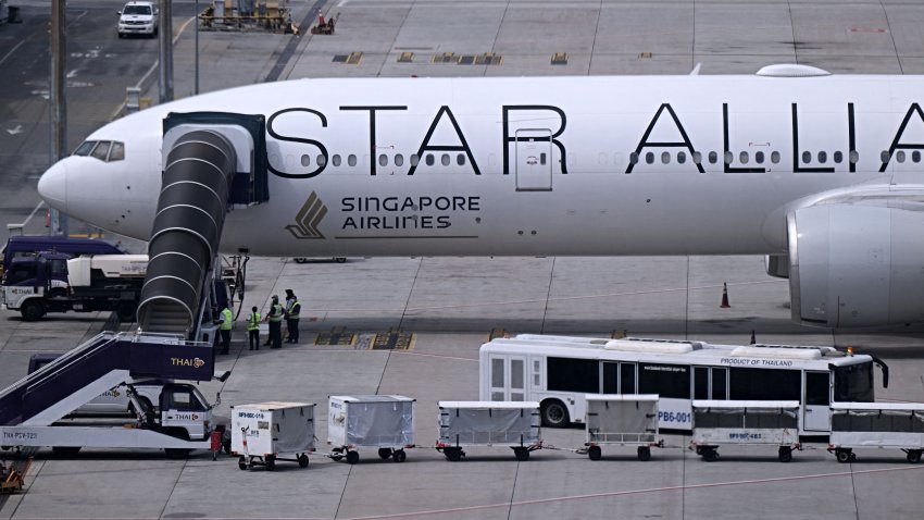 The Singapore Airlines Boeing 777-300ER airplane, which was headed to Singapore from London before making an emergency landing in Bangkok due to severe turbulence, is seen on the tarmac at Suvarnabhumi International Airport in Bangkok on May 22, 2024. A 73-year-old British man died and more than 70 people were injured on May 21 in what passengers described as a terrifying scene aboard Singapore Airlines flight SQ321 that hit severe turbulence, triggering an emergency landing in Bangkok. (Photo by Lillian SUWANRUMPHA / AFP) (Photo by LILLIAN SUWANRUMPHA/AFP via Getty Images)