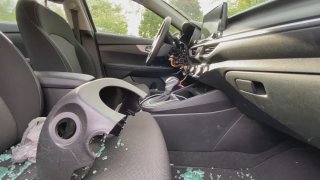 Steering column broken inside a 2022 Kia with window shattered