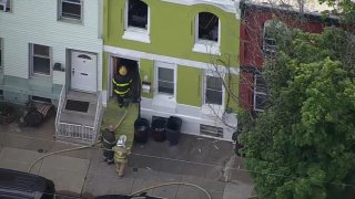 Firefighters walk into house after fire