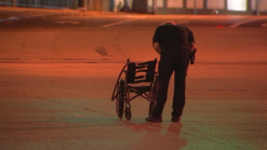 Police investigator examine damaged wheelchair.