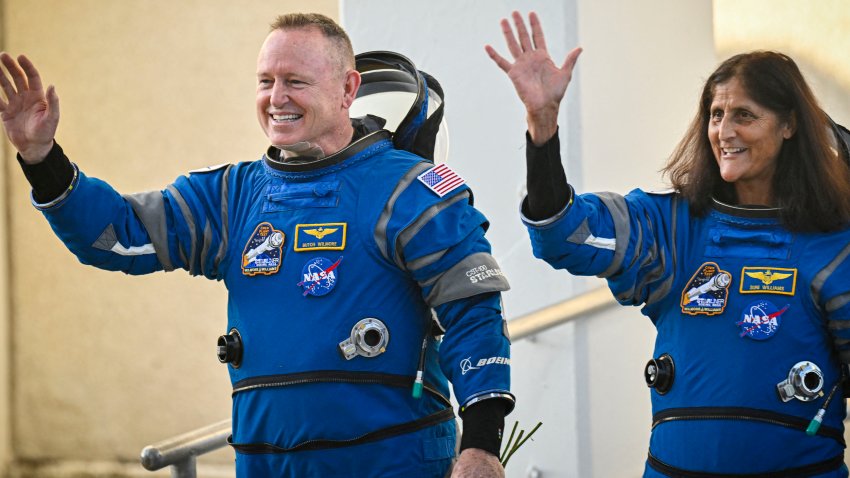 NASA astronauts  Butch Wilmore (L) and Suni Williams, wearing Boeing spacesuits, wave as they prepare to depart the Neil A. Armstrong Operations and Checkout Building at Kennedy Space Center for Launch Complex 41 at Cape Canaveral Space Force Station in Florida to board the Boeing CST-100 Starliner spacecraft for the Crew Flight Test launch, on June 5, 2024. Boeing on June 5 will try once more to launch astronauts aboard a Starliner capsule bound for the International Space Station. Liftoff is targeted for 10:52 am (1452 GMT) for a roughly one-week stay at the orbital laboratory. (Photo by Miguel J. Rodriguez Carrillo / AFP) (Photo by MIGUEL J. RODRIGUEZ CARRILLO/AFP via Getty Images)