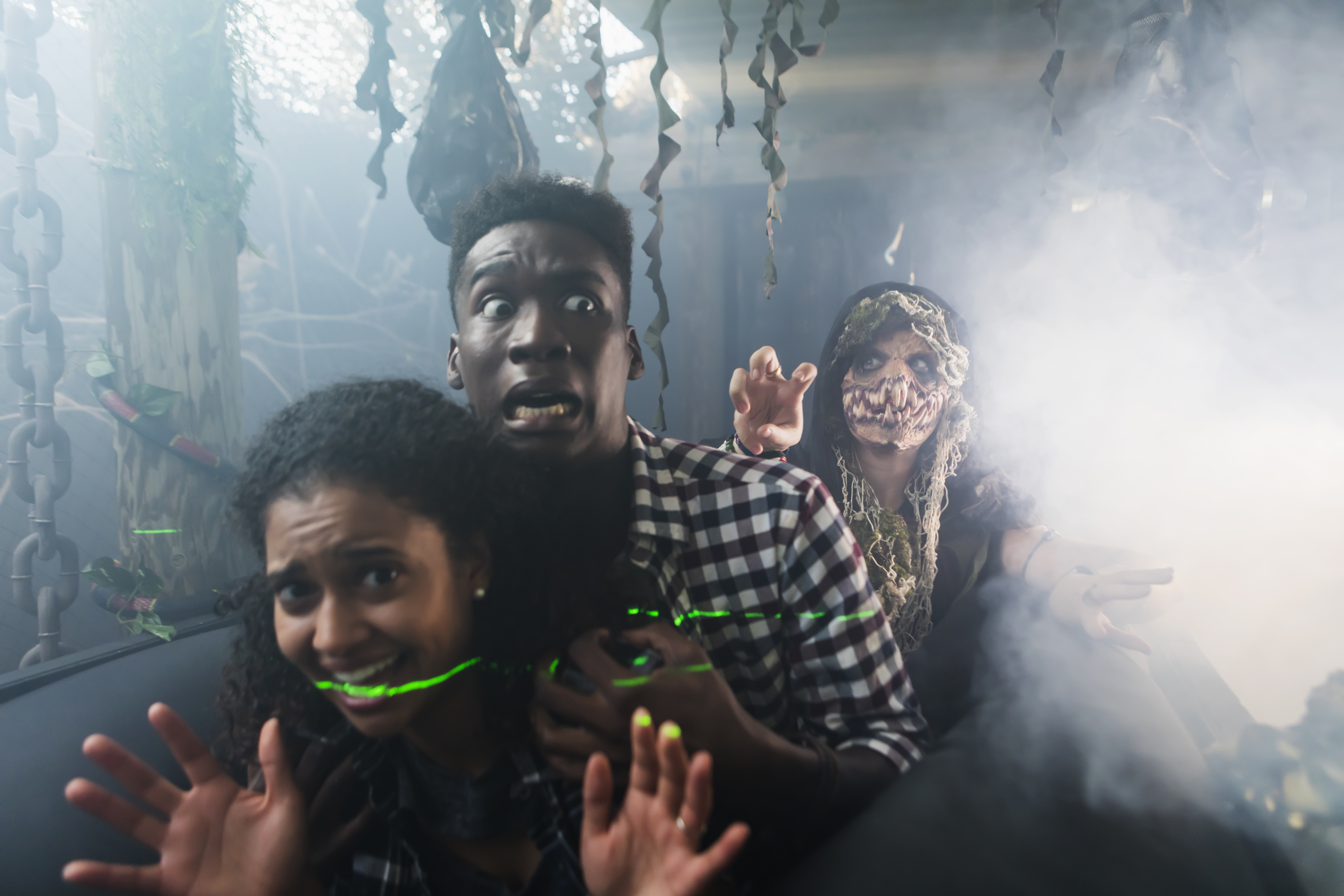 young adults having fun in a halloween haunted house.