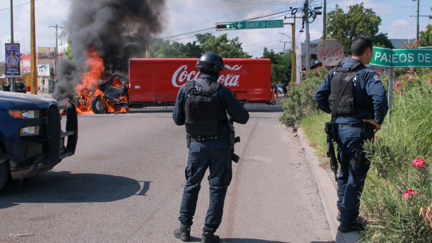 A truck on fire is seen on the streets of Culiacan, Sinaloa State, Mexico, on September 11, 2024. Elements of Mexico’s National Guard were deployed in the state of Sinaloa, in the northwest of the country, amid an escalation of violence that authorities attribute to internal struggles within the Sinaloa cartel following the capture of its leader, Ismael “Mayo” Zambada. (Photo by Ivan MEDINA / AFP) (Photo by IVAN MEDINA/AFP via Getty Images)