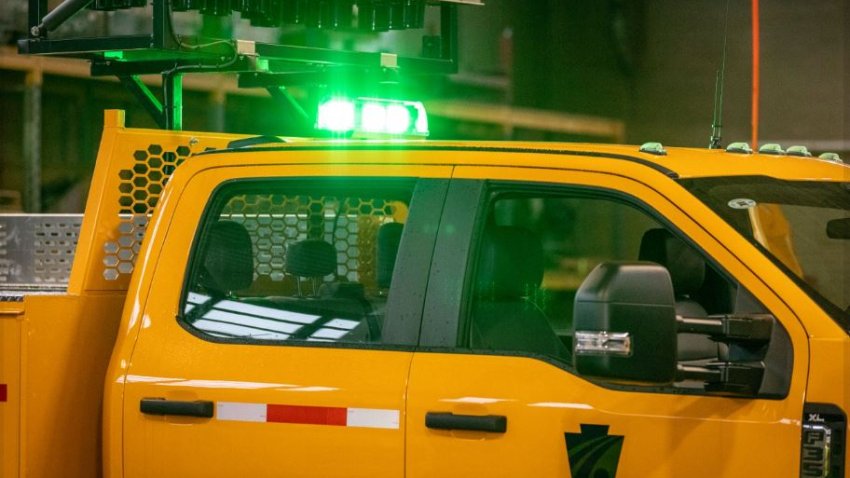 Green lights on top of yellow PennDOT truck