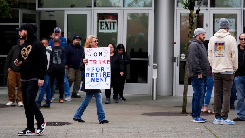 A worker holds a sign as Boeing employees vote on a new contract offer from the company