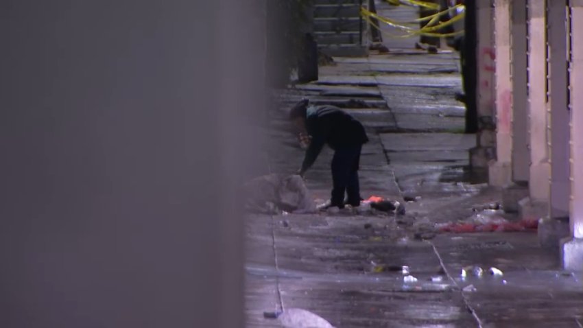 A police officer investigates after a man was shot and killed near the intersection of Emerald Street and East Lehigh Avenue in Kensington on Monday, Dec. 30, 2024.