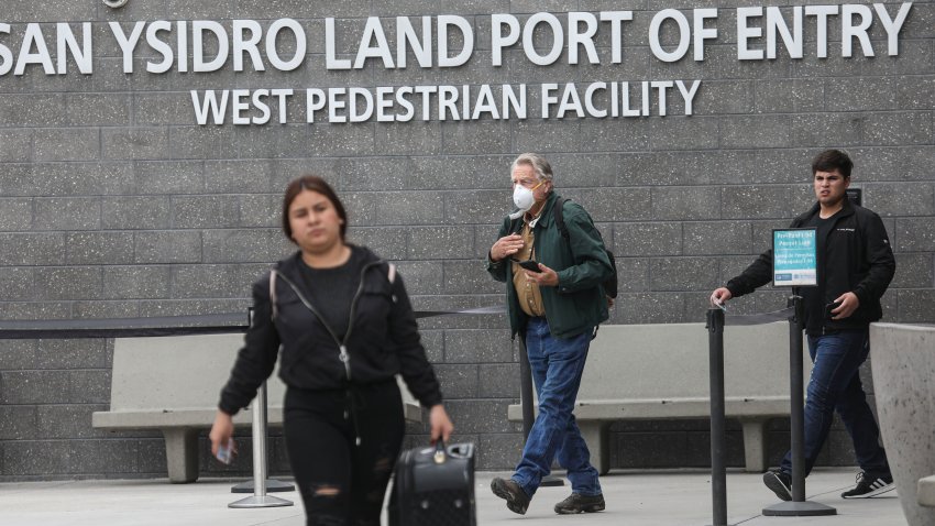 Pedestrians walk out of the United States Port of Entry after coming from Mexico along the US-Mexico border in San Ysidro, California on March 20, 2020. – United States announced Friday that it has agreed with Mexico and Canada to restrict non-essential travel because of the coronavirus outbreak and is planning to repatriate undocumented immigrants arriving from those countries. (Photo by Sandy Huffaker / AFP) (Photo by SANDY HUFFAKER/AFP via Getty Images)