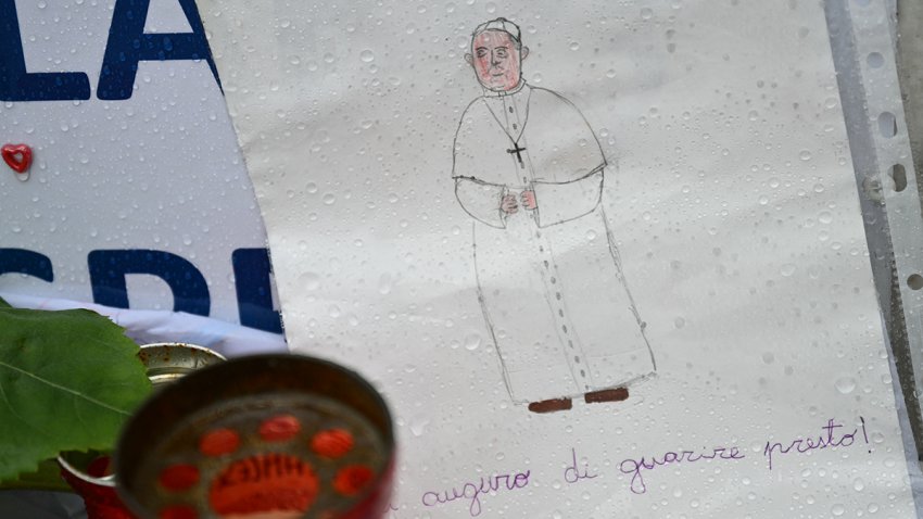 Drawings and messages of healing for Pope Francis are laid at the statue of John Paul II outside the Gemelli hospital where the Pope is hospitalized with pneumonia, in Rome on February 26, 2025.  (Photo by Alberto PIZZOLI / AFP) (Photo by ALBERTO PIZZOLI/AFP via Getty Images)