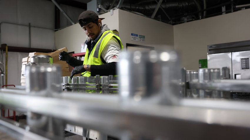 SACRAMENTO, CALIFORNIA – FEBRUARY 19: Edwin Flores pulls cans of freshly canned beer from an assembly line at The Can Van headquarters on February 19, 2025 in Sacramento, California. Craft brewers are bracing for a new tariff of 25 percent imposed by U.S. President Donald Trump on aluminum imports that is set to take effect on March 12 and could cause the price of canned beer and soft drinks to rise. Aluminum cans account for nearly 75 percent of packaged craft beer’s volume and revenue. (Photo by Justin Sullivan/Getty Images)