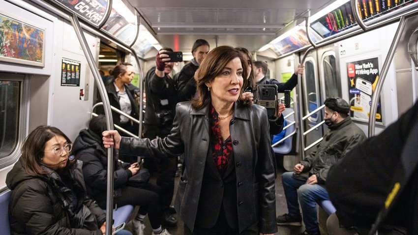 Kathy Hochul, governor of New York, center, on the uptown E train after a news conference on congestion pricing in New York, US, on Friday, March 21, 2025. The Trump administration has reiterated a demand for New York to end its congestion pricing program, providing officials with a 30-day extension to turn off the tolls. Photographer: Yuki Iwamura/Bloomberg via Getty Images