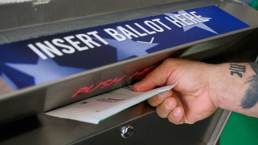 A voter uses a ballot drop box at the Bucks County Administration building voting on demand and ballot drop center in Doylestown, Pennsylvania, on October 31, 2024. (Photo by Ed JONES / AFP) (Photo by ED JONES/AFP via Getty Images)